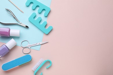 Set of pedicure tools on color background, flat lay. Space for text