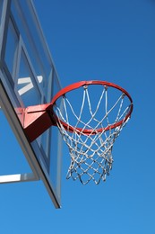 Photo of Basketball hoop with net outdoors on sunny day