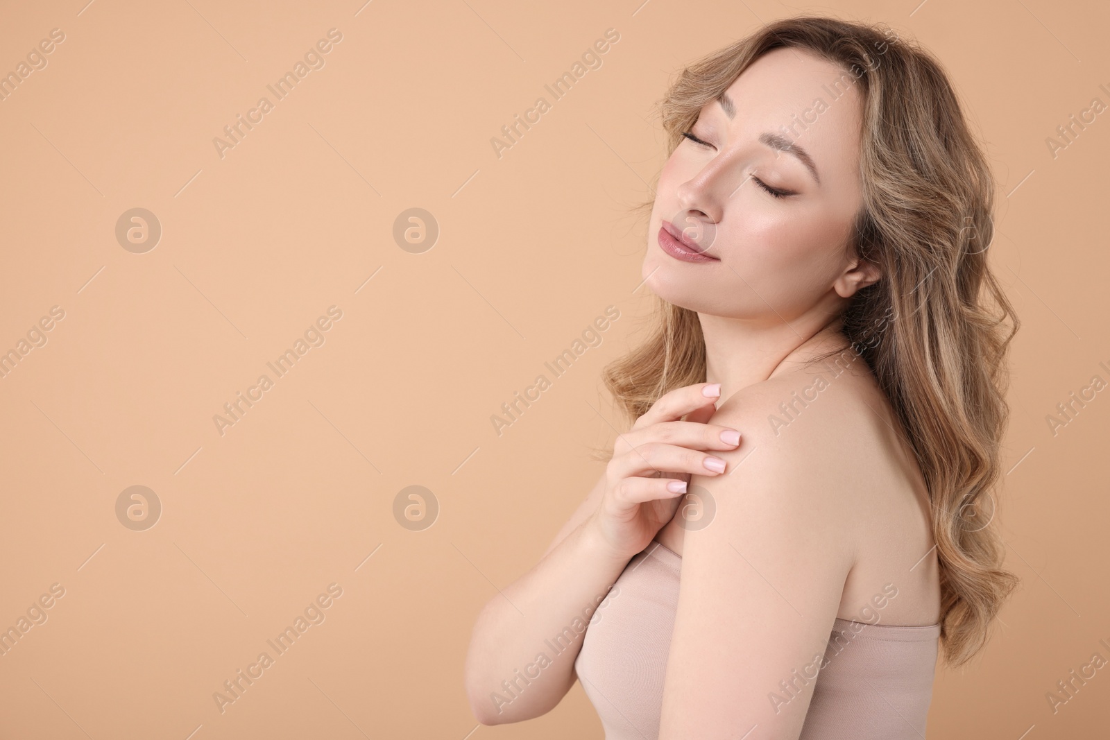 Photo of Portrait of beautiful woman on beige background. Space for text