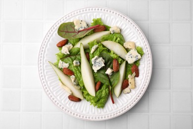 Photo of Delicious pear salad on white tiled table, top view