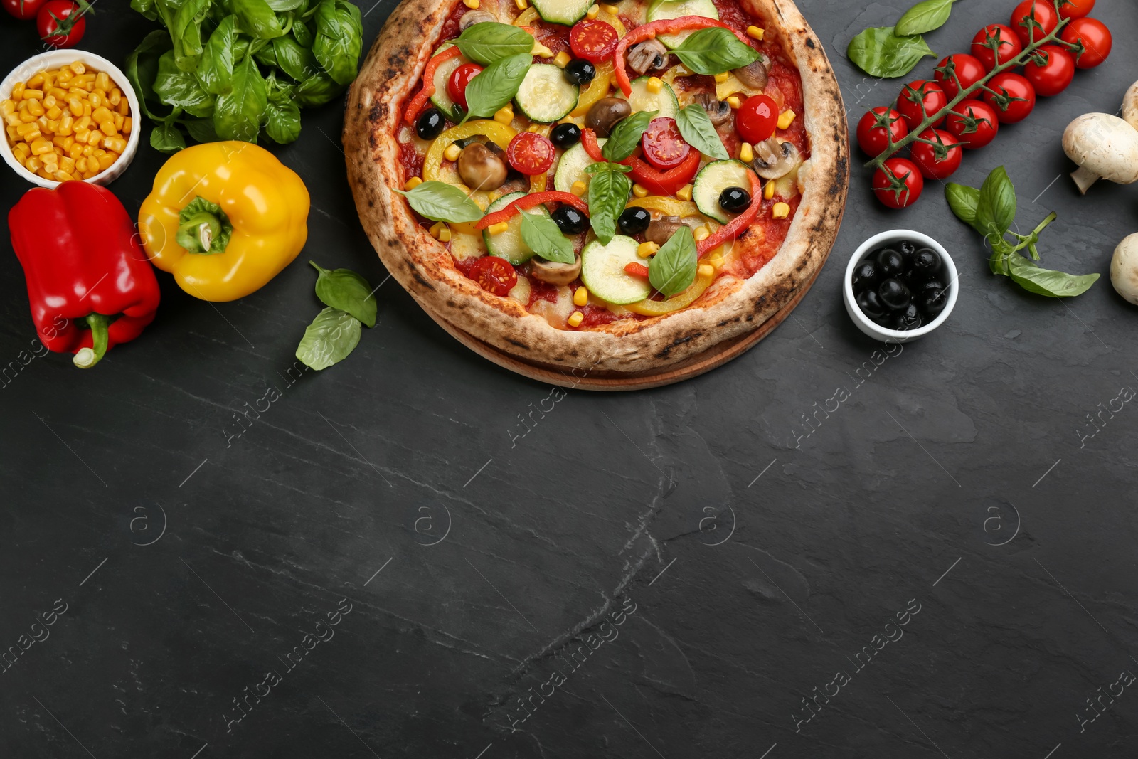 Photo of Flat lay composition with delicious hot vegetable pizza on black table. Space for text