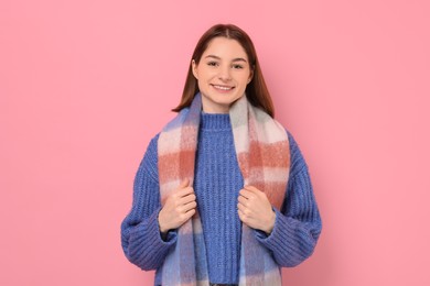 Photo of Beautiful woman in warm scarf on pink background