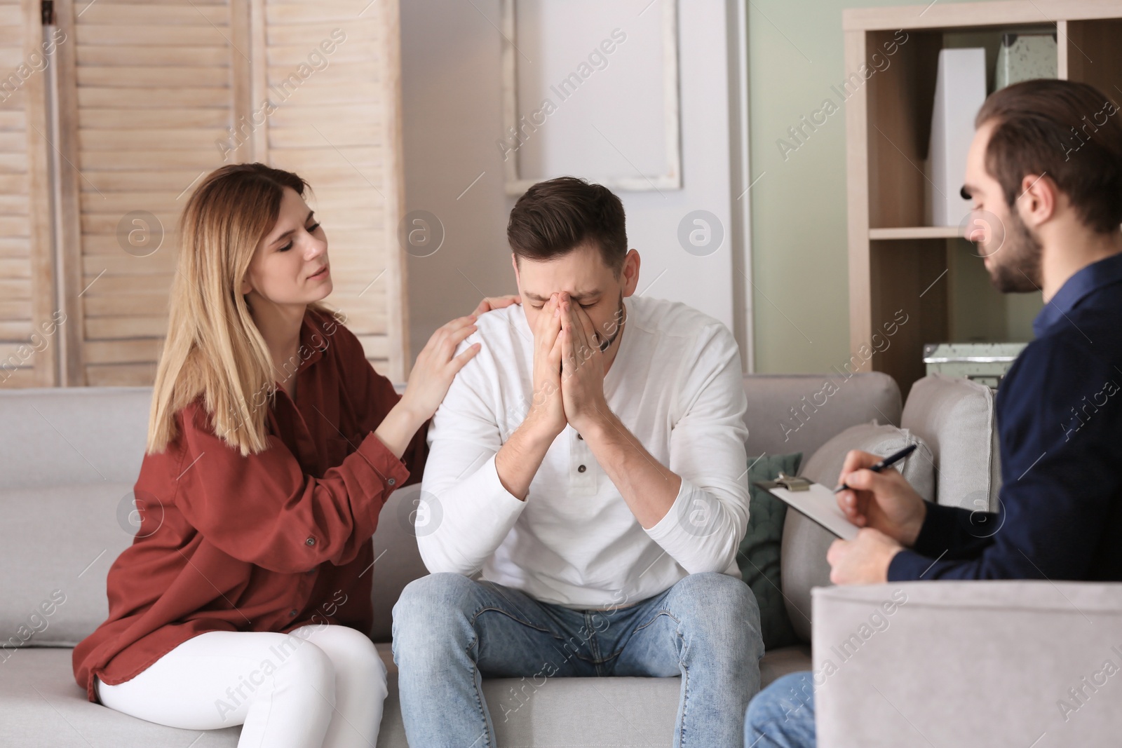 Photo of Family psychologist working with young couple in office