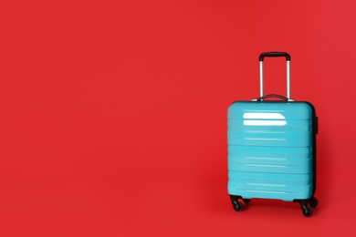 Photo of Stylish suitcase on color background. Space for text