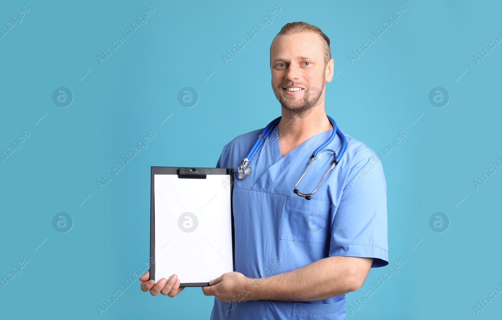 Photo of Portrait of medical assistant with stethoscope and clipboard on color background. Space for text