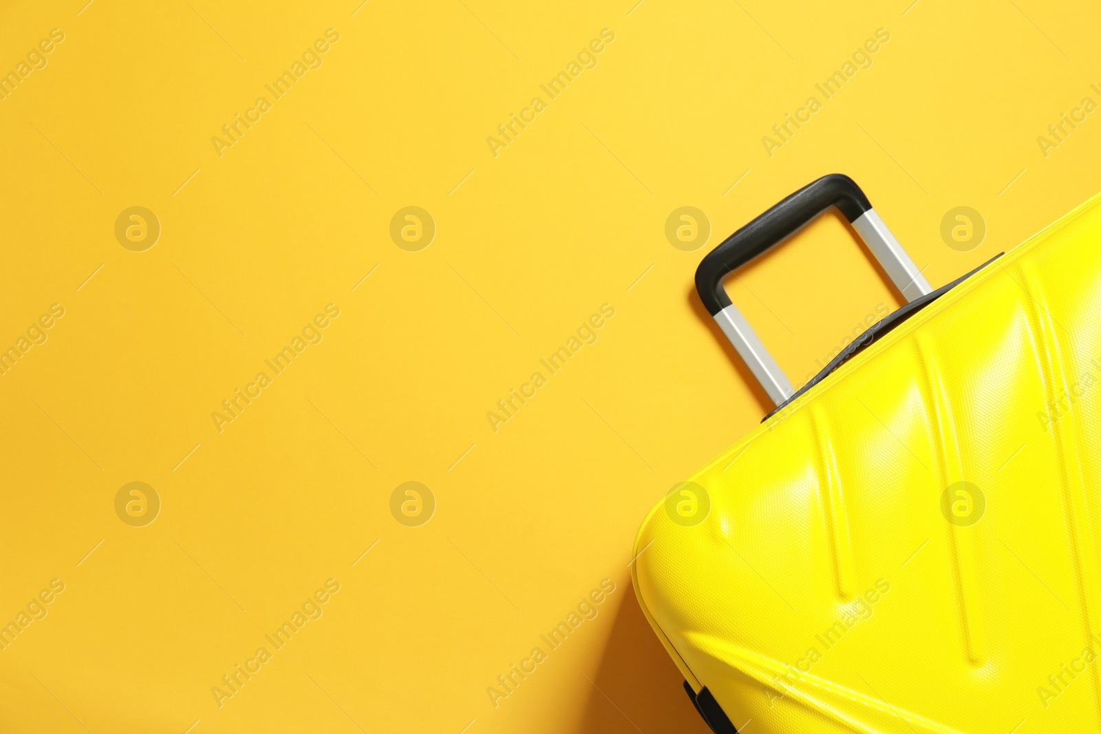 Photo of Bright suitcase on color background, top view with space for text