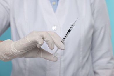 Photo of Doctor holding syringe with needle, closeup view