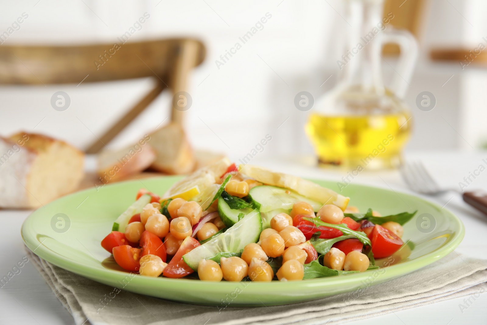 Photo of Delicious fresh chickpea salad on white table