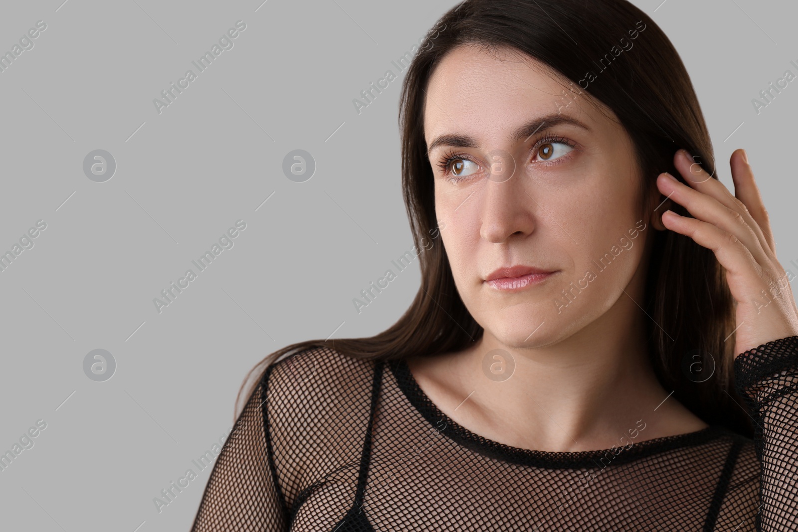 Photo of Portrait of beautiful young woman on light grey background