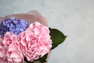 Photo of Bouquet of beautiful hortensia flowers on color background. Space for text