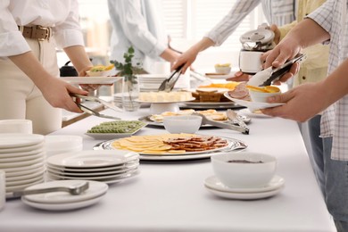 People taking food during breakfast, closeup. Buffet service