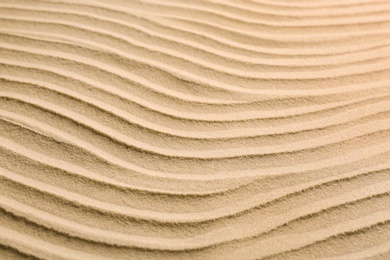 Photo of Dry beach sand as background, closeup view