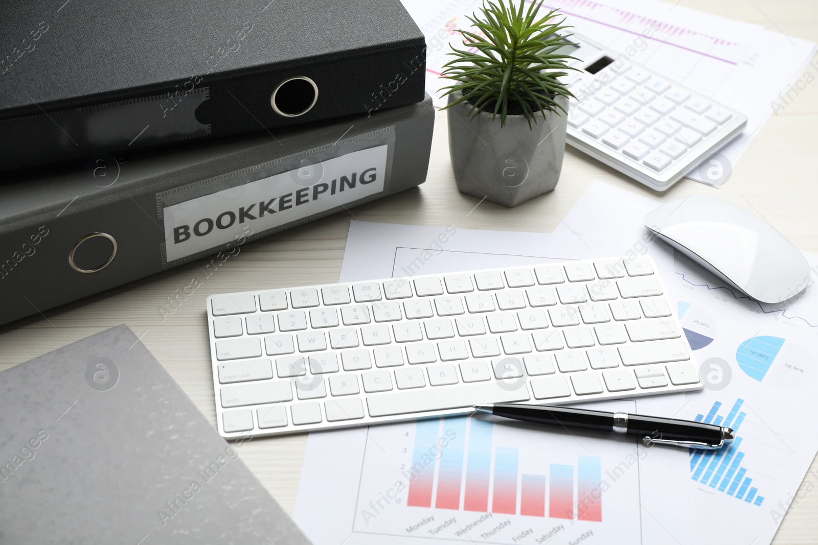 Photo of Bookkeeper's workplace with folders and documents on table