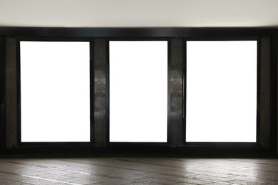 Photo of Blank advertising boards on wall in subway. Mockup for design