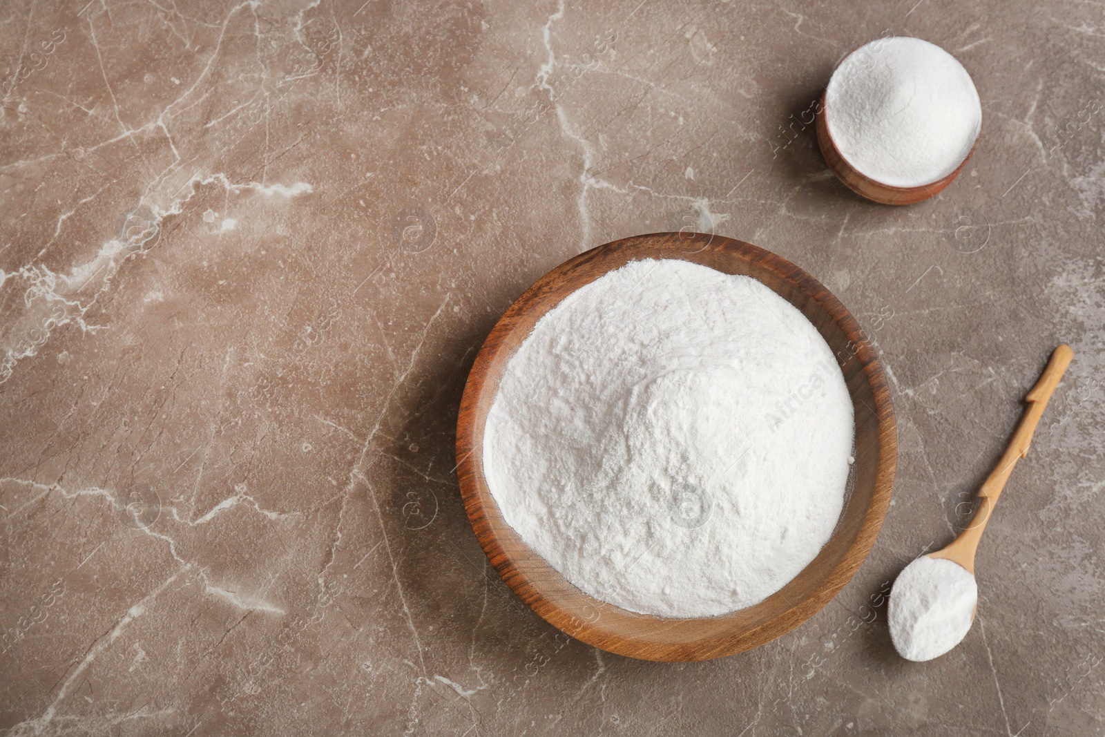 Photo of Flat lay composition with bowls of baking soda and space for text on table