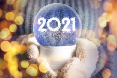 Image of 2021 New Year greeting card design. Snow globe with numbers