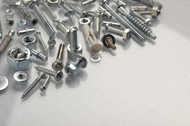 Many different fasteners on plastic surface, closeup. Space for text