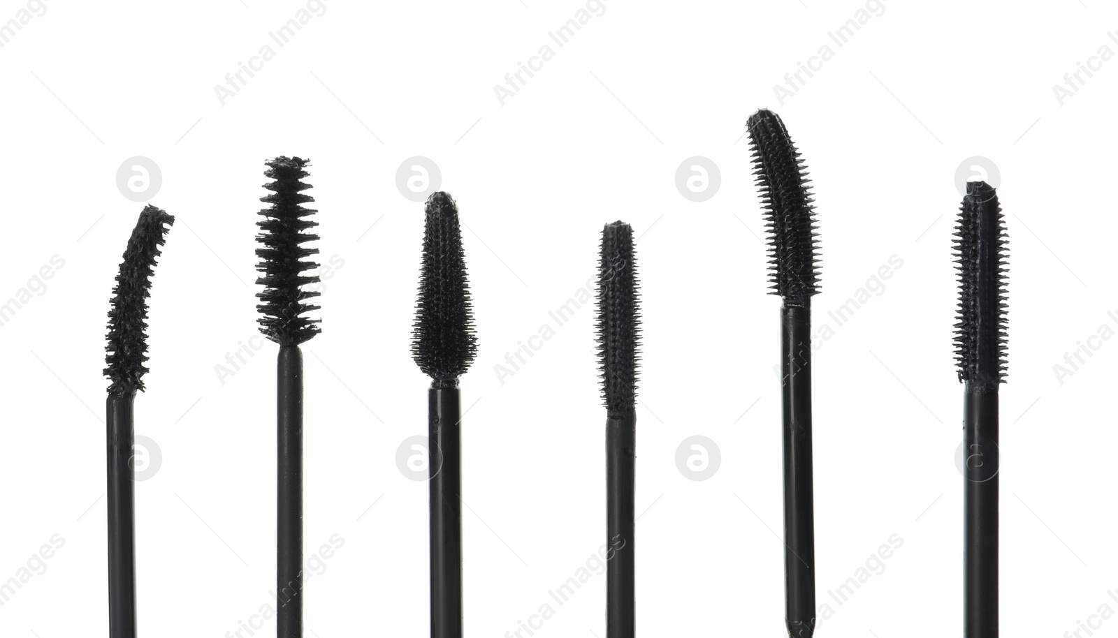 Photo of Many mascara wands for eyelashes on white background. Makeup product