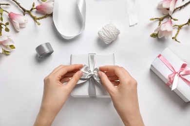 Photo of Woman with beautiful gift boxes on white background, top view