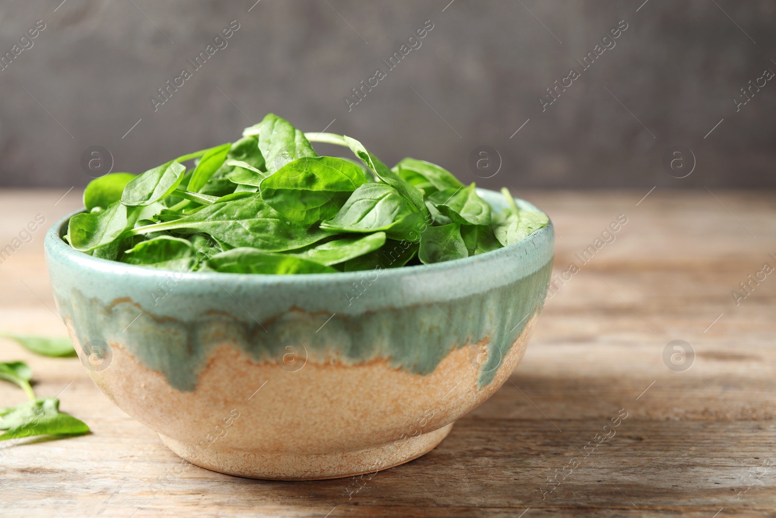 Photo of Fresh green healthy spinach on wooden table