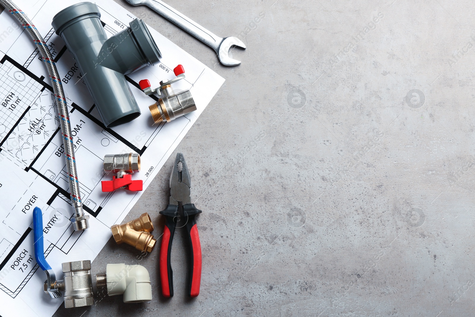 Photo of Flat lay composition with plumber's tools and space for text on grey background