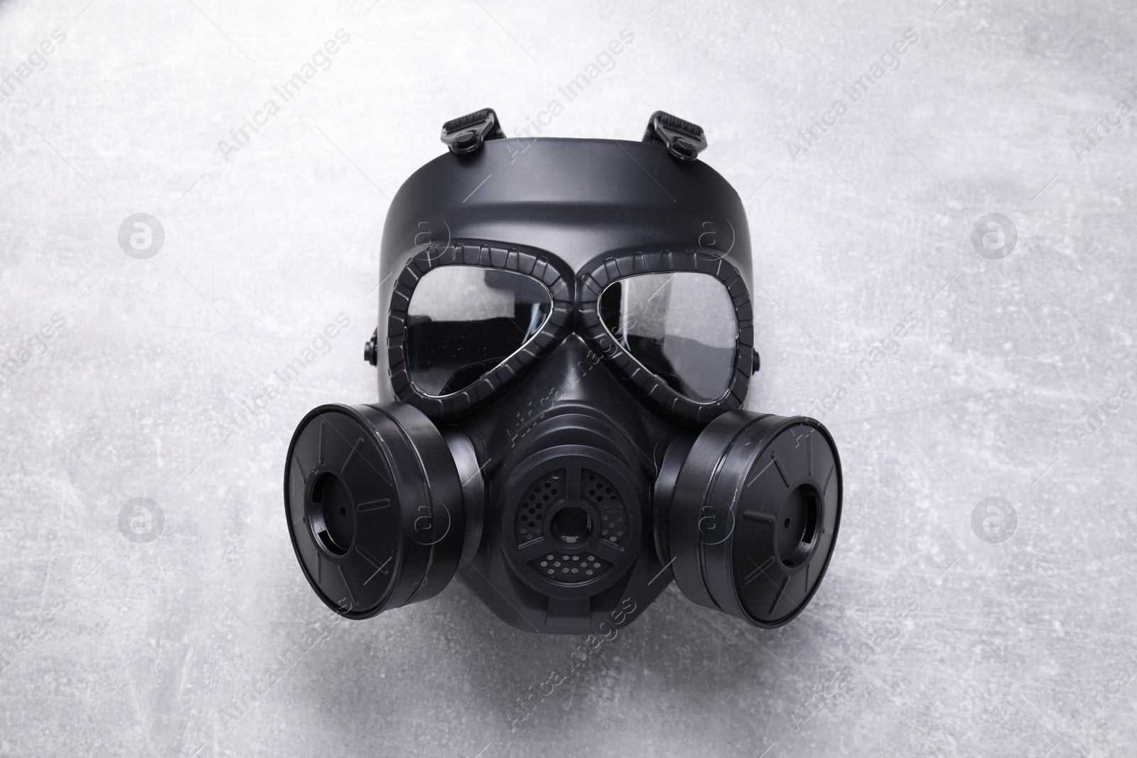 Photo of One gas mask on grey textured background, top view