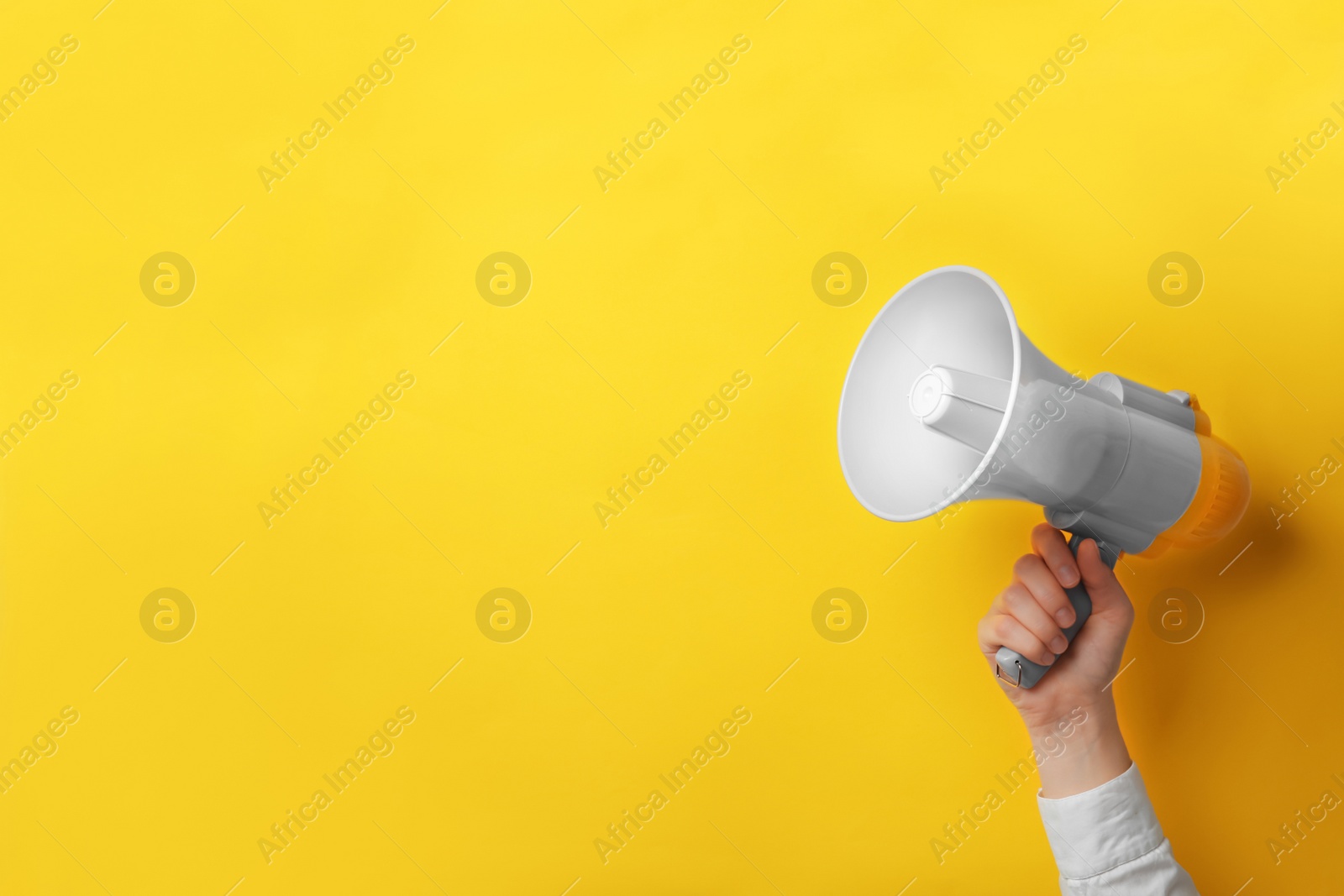 Photo of Man holding megaphone on color background