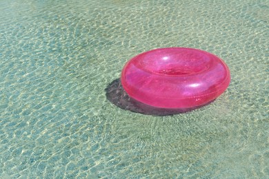Photo of Bright inflatable ring floating on sea water. Space for text