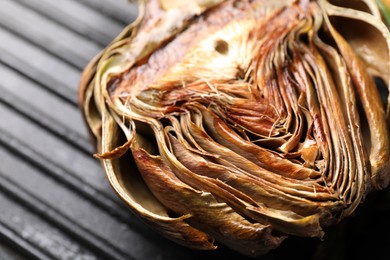 Photo of Pan with tasty grilled artichoke, closeup view