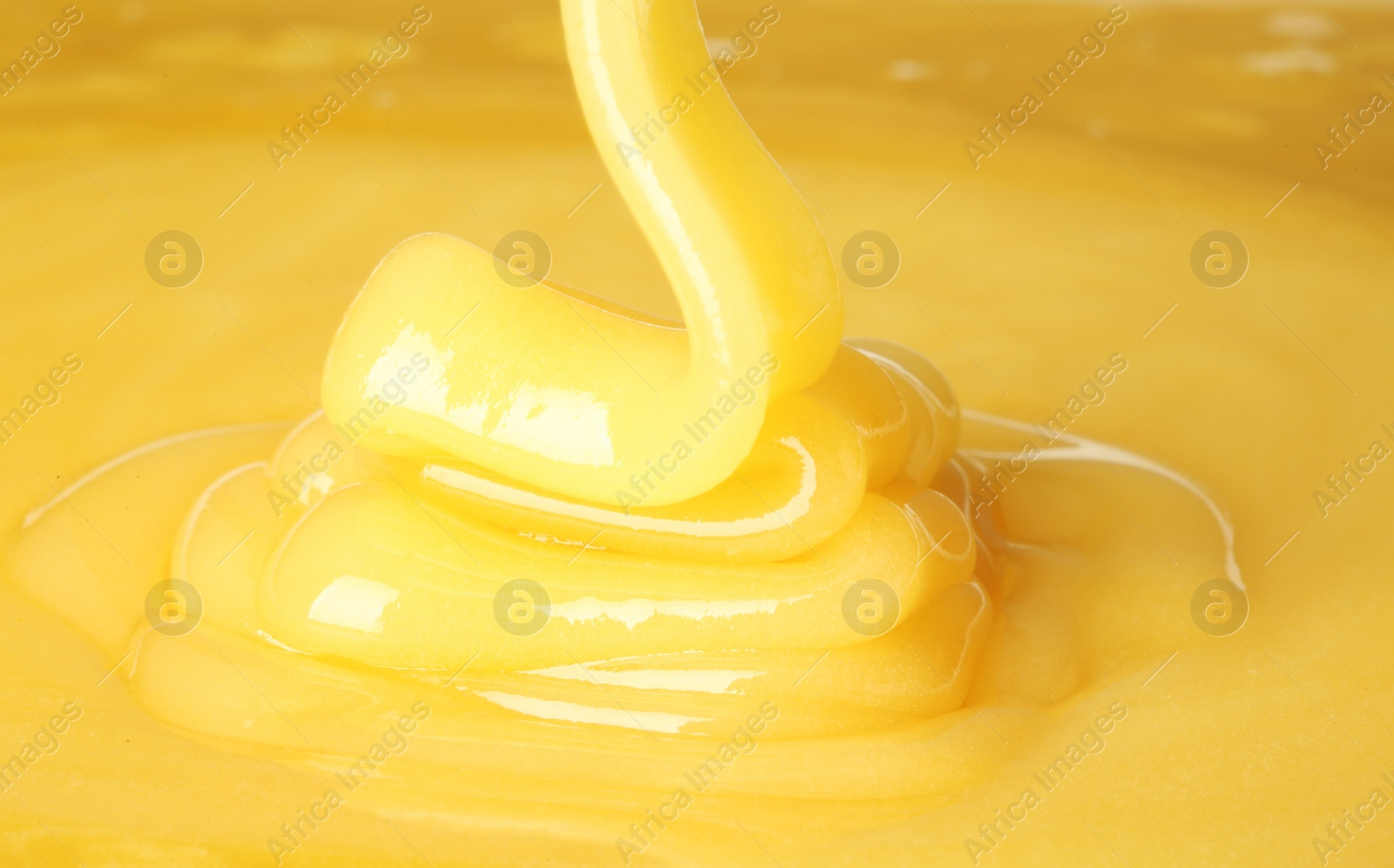 Photo of Pouring fresh sweet honey, closeup