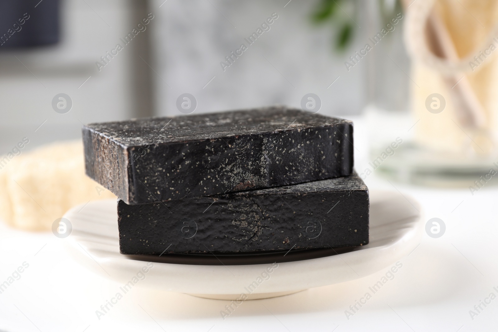 Photo of Natural tar soap on white table, closeup