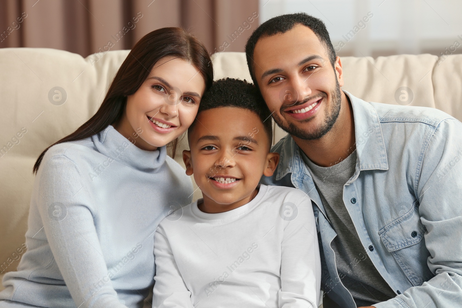 Photo of Happy international family on sofa at home