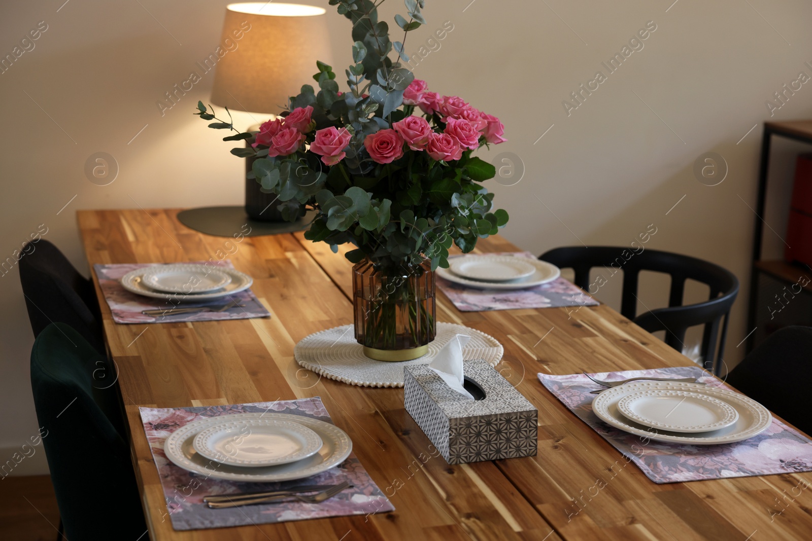 Photo of Beautiful table setting with bouquet and napkins indoors. Roses and eucalyptus branches in vase