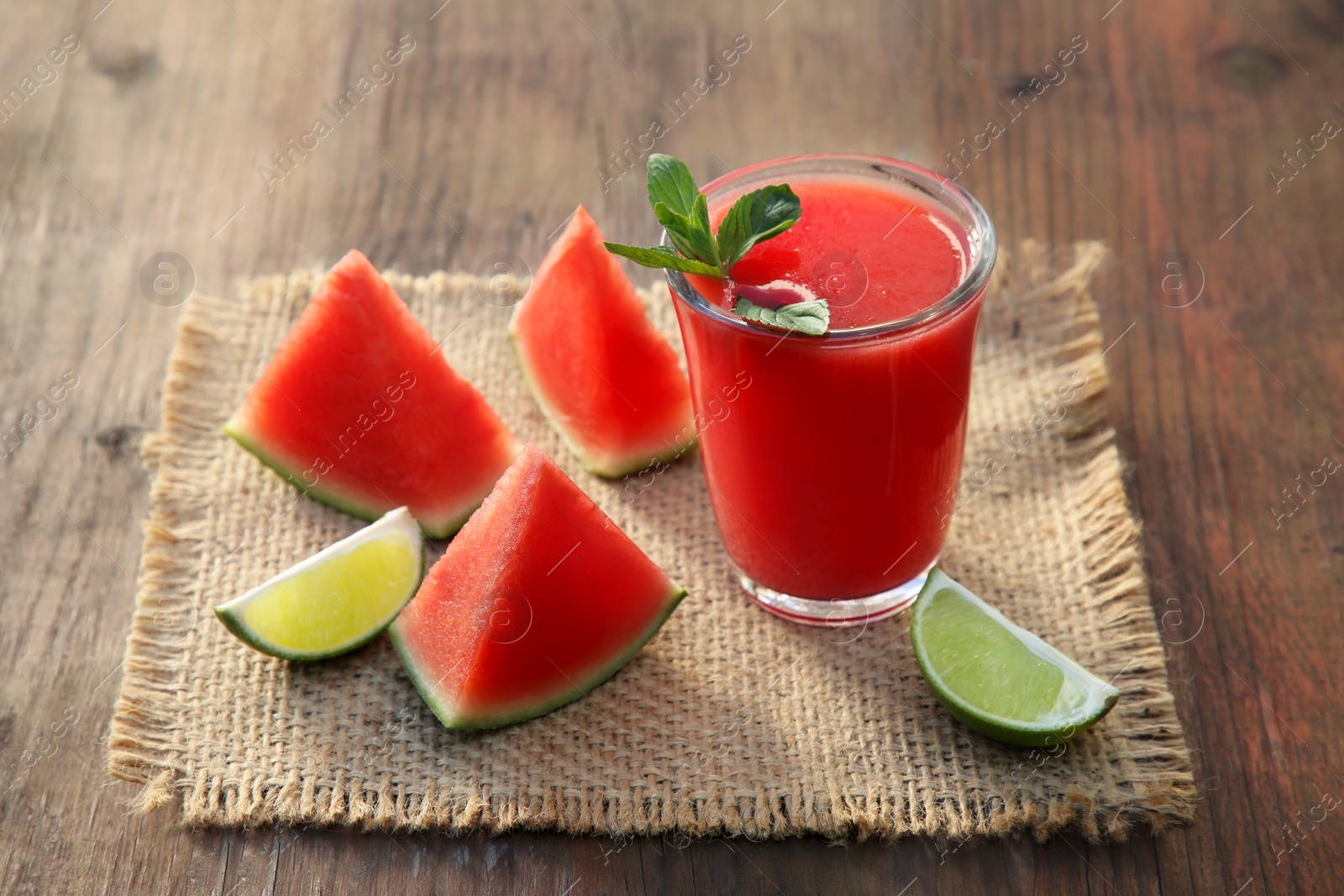 Photo of Delicious watermelon drink and fresh fruits on wooden table