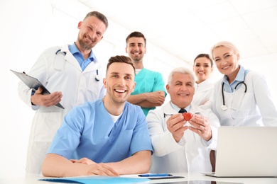 Photo of Group of doctors attending meeting in clinic. Cardiology conference