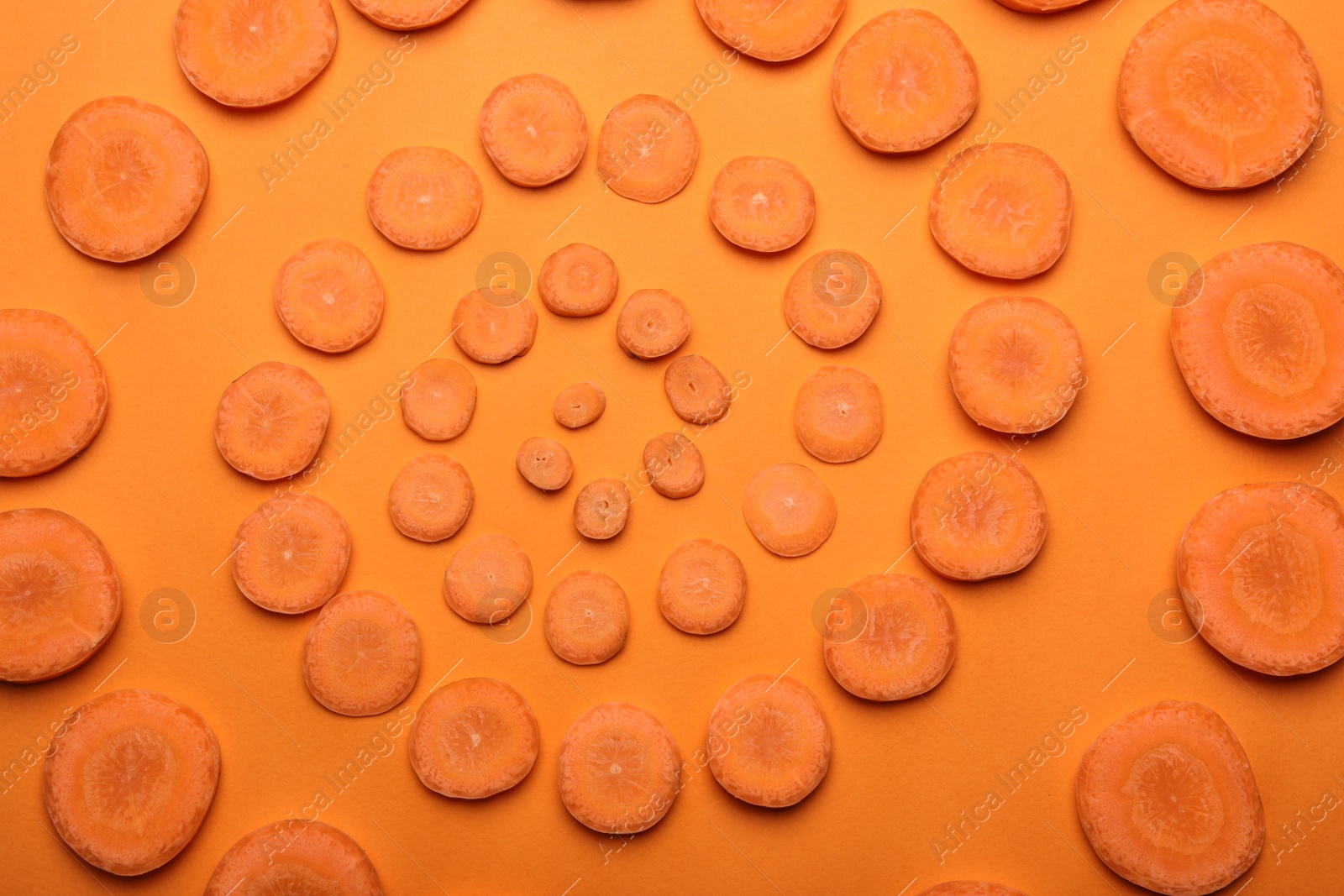 Photo of Flat lay composition with fresh carrot slices on color background