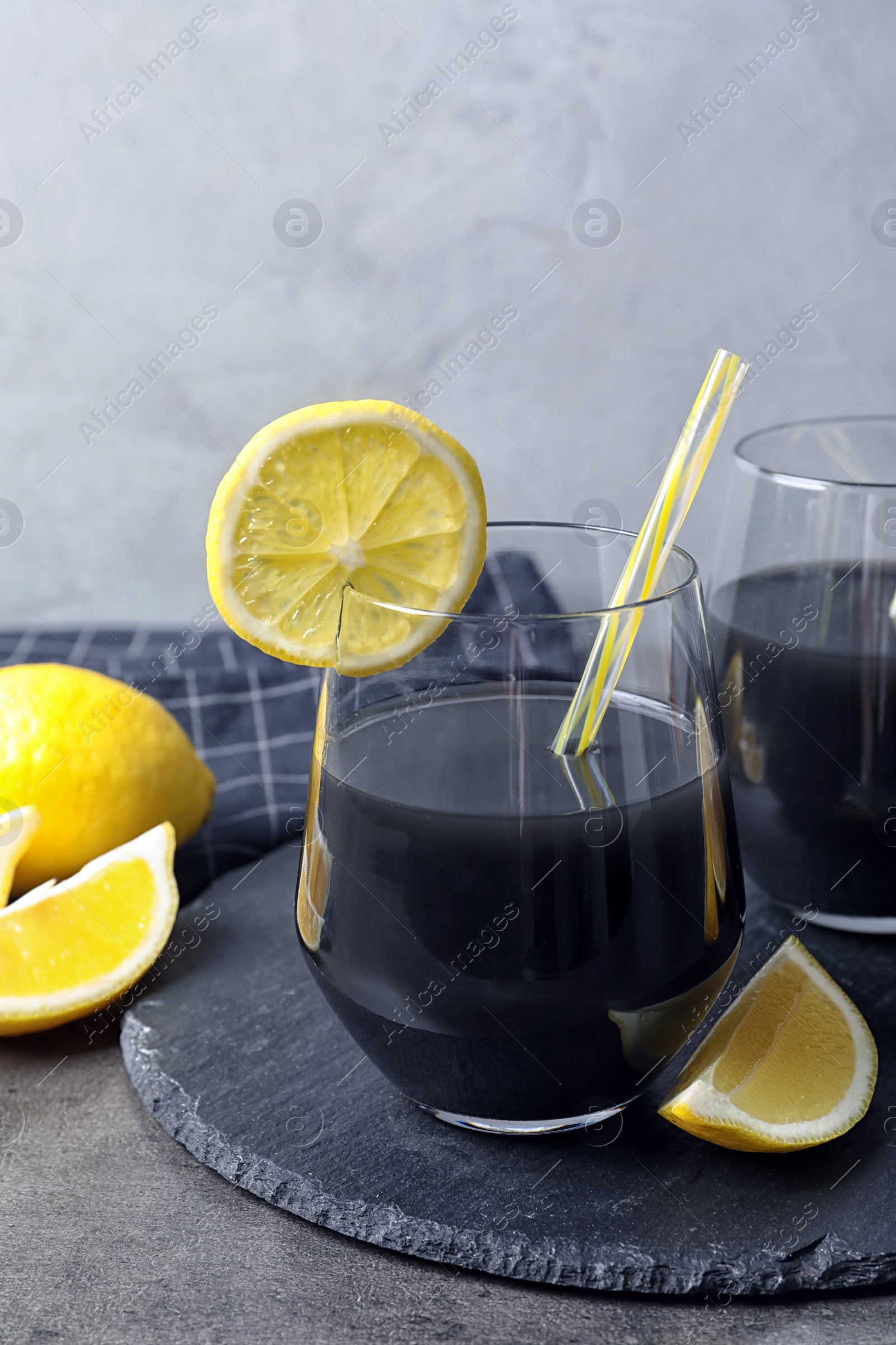 Photo of Glasses with natural black lemonade on table