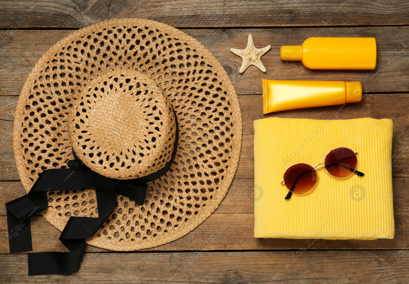 Photo of Flat lay composition with beach accessories on wooden background