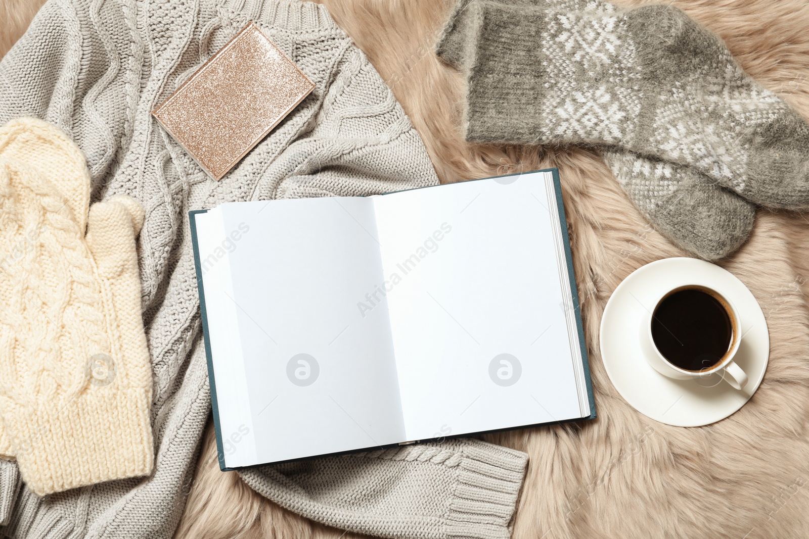 Photo of Flat lay composition with book, cup of coffee and warm clothes on fuzzy rug. Space for text