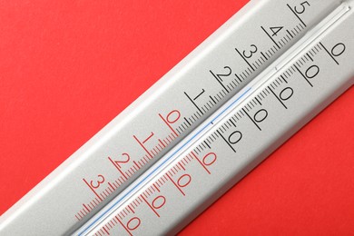 Photo of Modern weather thermometer on red background, closeup