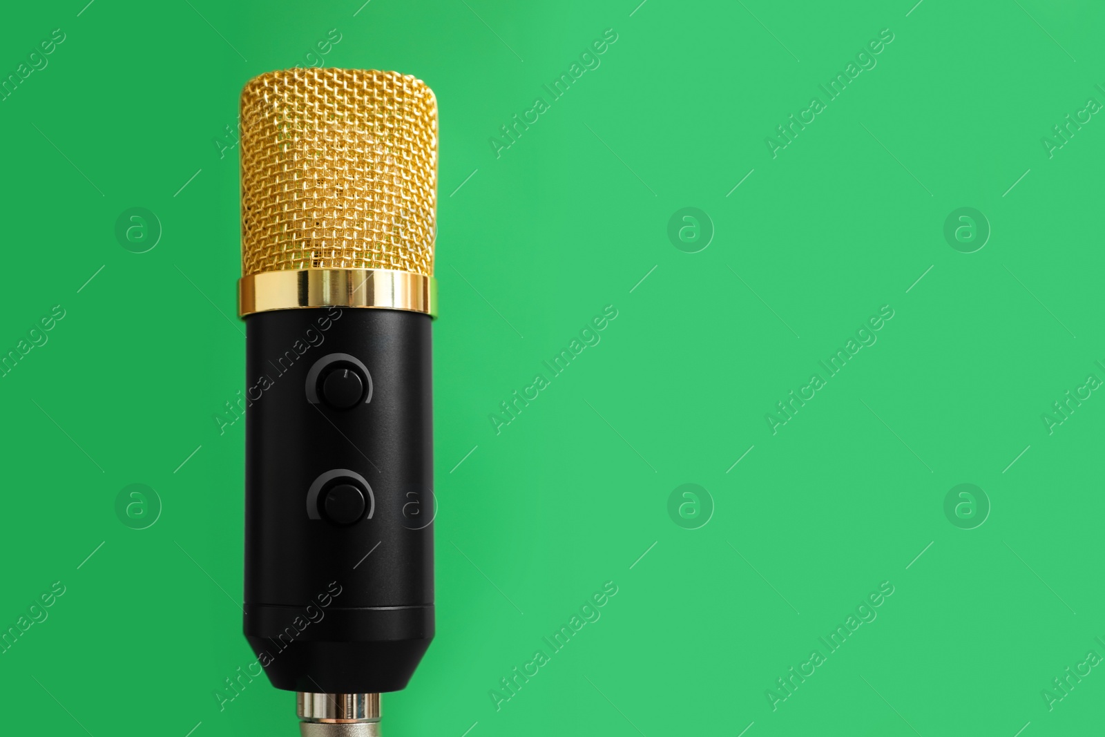 Photo of Microphone on green background, space for text. Journalist's work