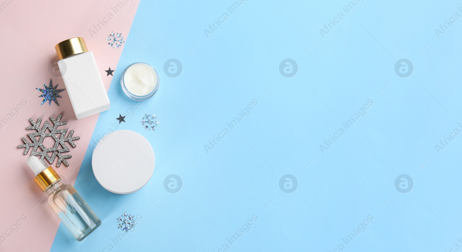 Photo of Flat lay composition with different cosmetic products on color background, space for text. Winter care