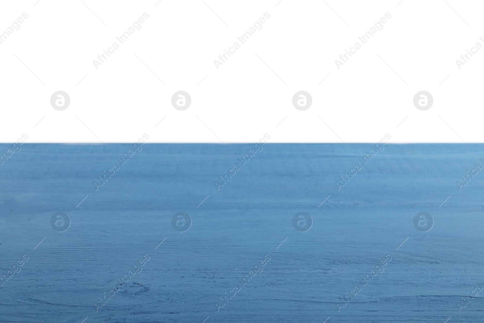 Photo of Empty blue wooden surface on white background. Space for text