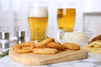 Fried onion rings served on white marble table