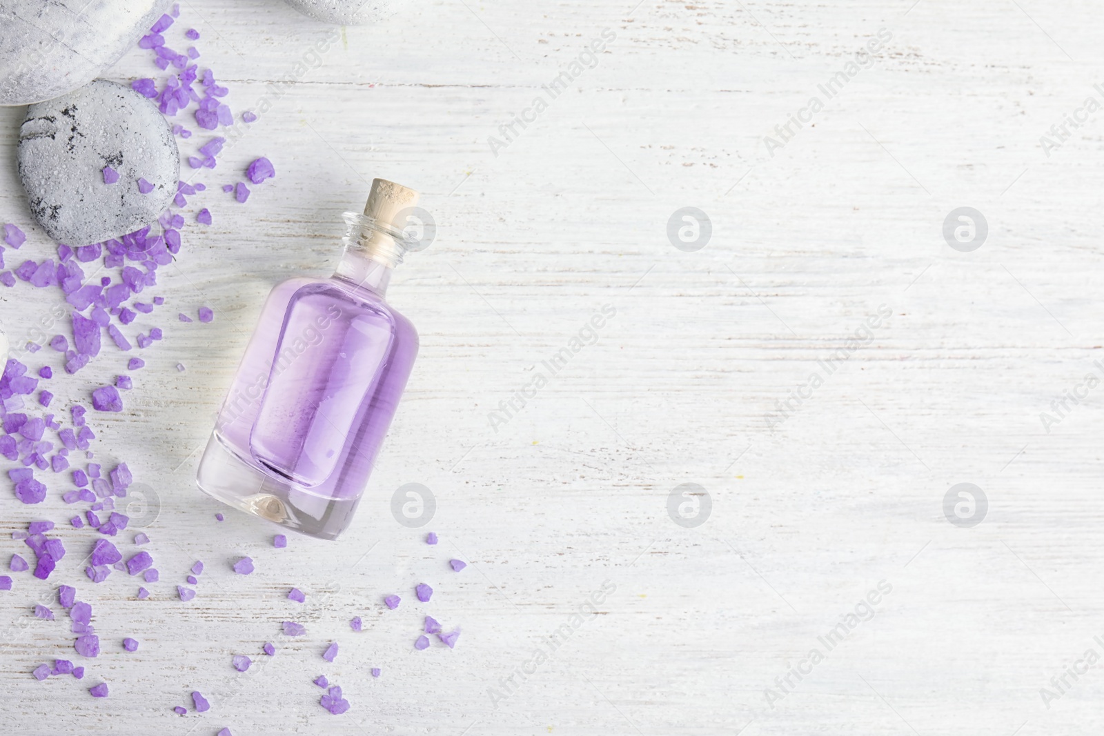 Photo of Flat lay composition with natural lavender oil on wooden background. Space for text