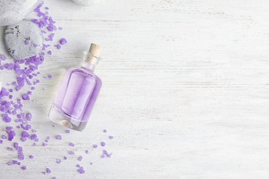 Photo of Flat lay composition with natural lavender oil on wooden background. Space for text
