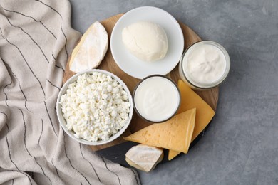 Different fresh dairy products on grey table, top view