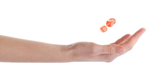 Photo of Woman throwing game dices on white background, closeup