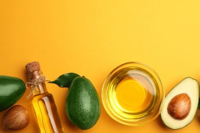 Photo of Cooking oil and fresh avocados on yellow background, flat lay. Space for text