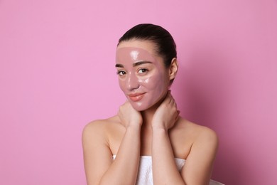 Photo of Woman with pomegranate face mask on pink background